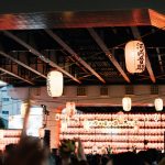 Paper lanterns hang under a bridge during a festival.